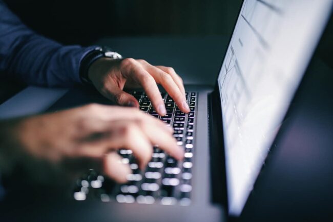 Image of an individual attentively analyzing a detailed cash flow forecast on their computer screen, provided by Juna Financial Solutions, indicating strategic financial planning.