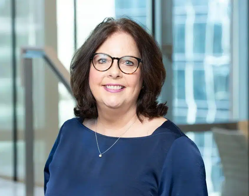 Professional portrait of Ann Marie Williams, Client Operations Manager at Juna Financial Solutions, exuding confidence and professionalism as she smiles at the camera.