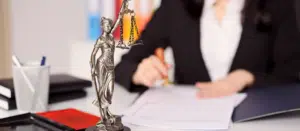 Image of a focused woman attorney meticulously reviewing IOLTA and Trust accounting documents. These comprehensive resources have been provided by Juna Financial Solutions, aiding in her understanding and management of client funds in accordance with legal and ethical guidelines.