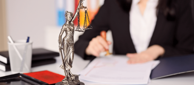 Image of a focused woman attorney meticulously reviewing IOLTA and Trust accounting documents. These comprehensive resources have been provided by Juna Financial Solutions, aiding in her understanding and management of client funds in accordance with legal and ethical guidelines.