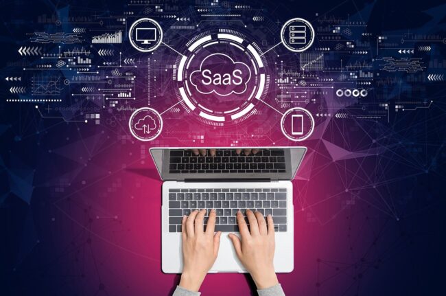 a person is on a laptop viewing SaaS KPIs and Metrics for their business
